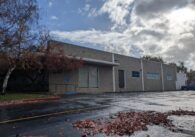 The outside of a vacant one-story building.