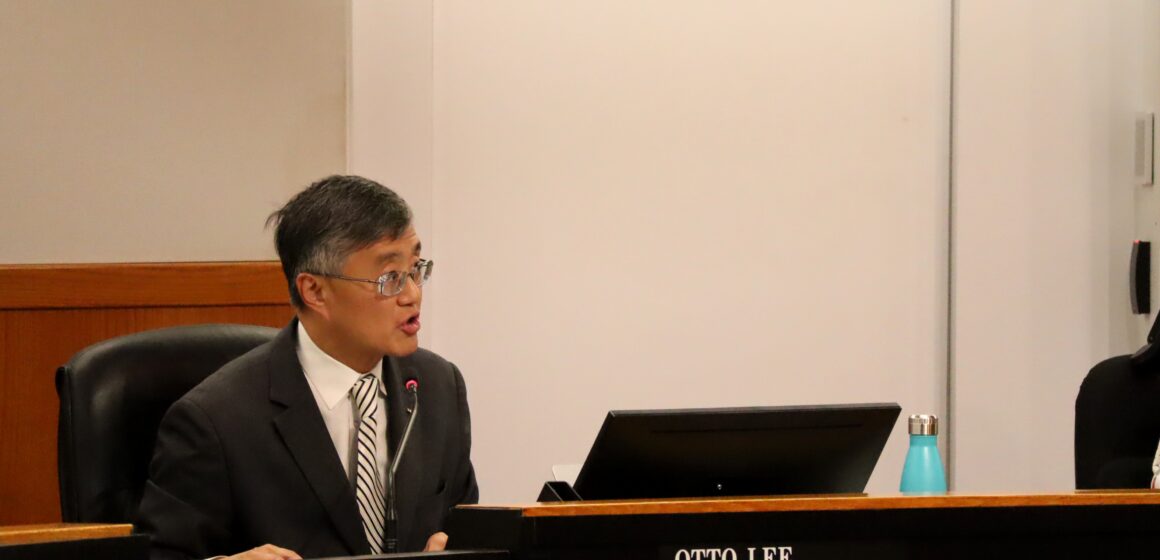 Otto Lee, District 3 Supervisor, speaking from board dias. Man with square glasses and short black-grey hair wearing a suit with a striped tie.