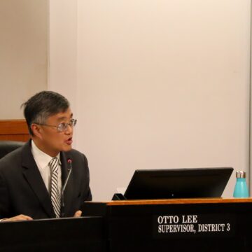 Santa Clara County Board of Supervisors Otto Lee Otto Lee, District 3 Supervisor, speaking from board dias. Man with square glasses and short black-grey hair wearing a suit with a striped tie.