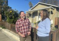 Man and woman in front of a house