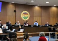 Members of a city council in the meeting chambers