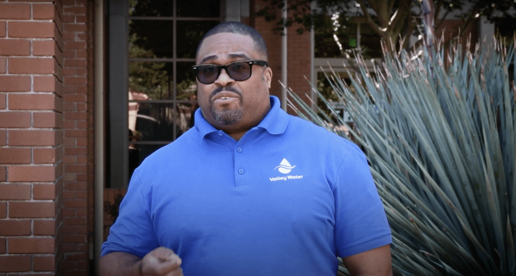 A man wearing a polo shirt and sunglasses