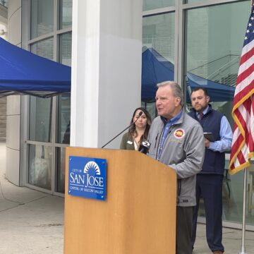 A man speaks at a podium outside in San Jose, California