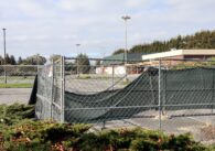 Empty parking lot and building fenced in