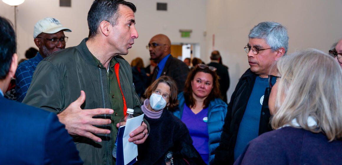 A man speaks to a crowd of people