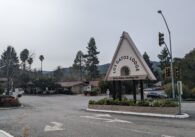 The entrance to the Los Gatos Lodge, with a triangular sign that reads "Los Gatos Lodge"