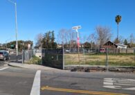 A fence enclosed around an empty lot