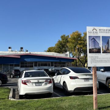 Gateway Tower A parking lot with a development project sign in the foreground