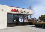 The outside of a smoke shop, with signs that read 420 Lifestyles, We sell CBD and CBD gummies