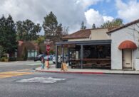 The corner of a town street with a cafe named Cafe Dio