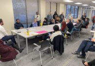 A group of people sitting around a table