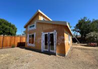 An ADU under construction with wood exposed and construction markings.
