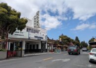 A small downtown street with an old-fashioned movie theater