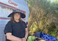 Woman in hat standing outdoors