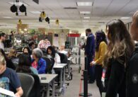 Election observers watch workers manually count voter ballots