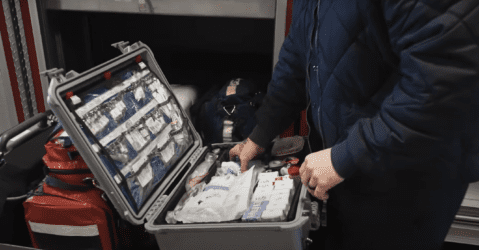A firefighter with a medication box