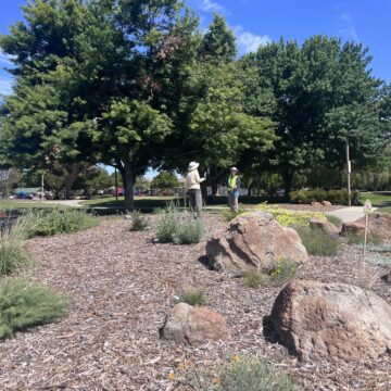 PARKS BUDGET Two people standing in a native garden at a park in San Jose, California