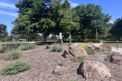 Two people standing in a native garden at a park in San Jose, California