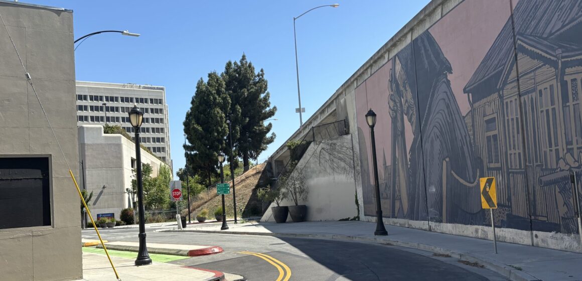A street mural overlooking a San Jose intersection along the freeway.