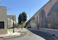 A street mural overlooking a San Jose intersection along the freeway.