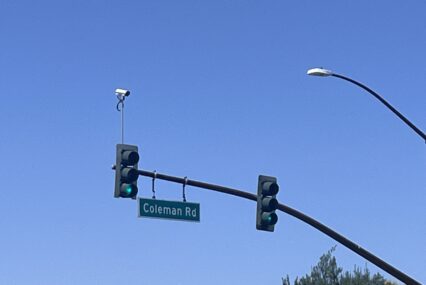 an automated license plate reader camera on top of a stoplight in San Jose, California