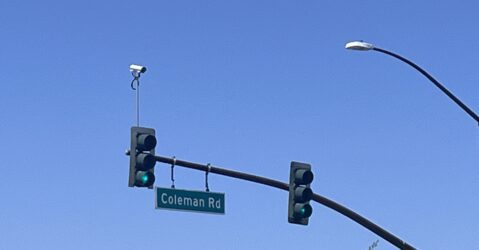 an automated license plate reader camera on top of a stoplight in San Jose, California