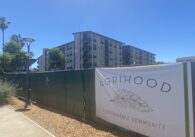 A chain fence in front of a housing complex