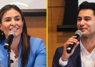 Two City Council candidates in a side-by-side photo sitting in front of microphones at a crowded forum.
