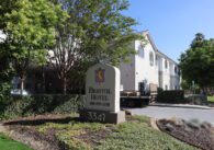 A beige hotel building with a sign that reads Bristol Hotel