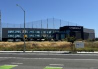 An across-the-street view of North San Jose's Topgolf location among dead grass and leaves.