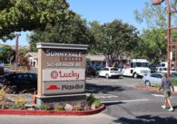 Photo of a parking lot and sign showing the address of Sunnyvale Square, 340-498 Maude Ave, where there's a Lucky Supermarket and Pizza Hut