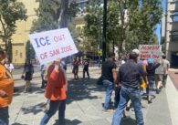 Protesters walking on the street in San Jose carrying signs