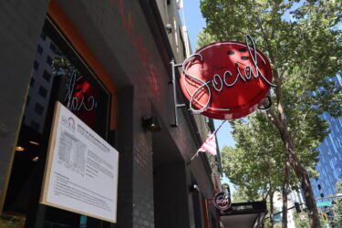 A neon sign above a nightclub in downtown San Jose