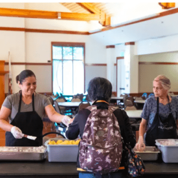 Woman serving older adults food