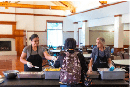 Woman serving older adults food