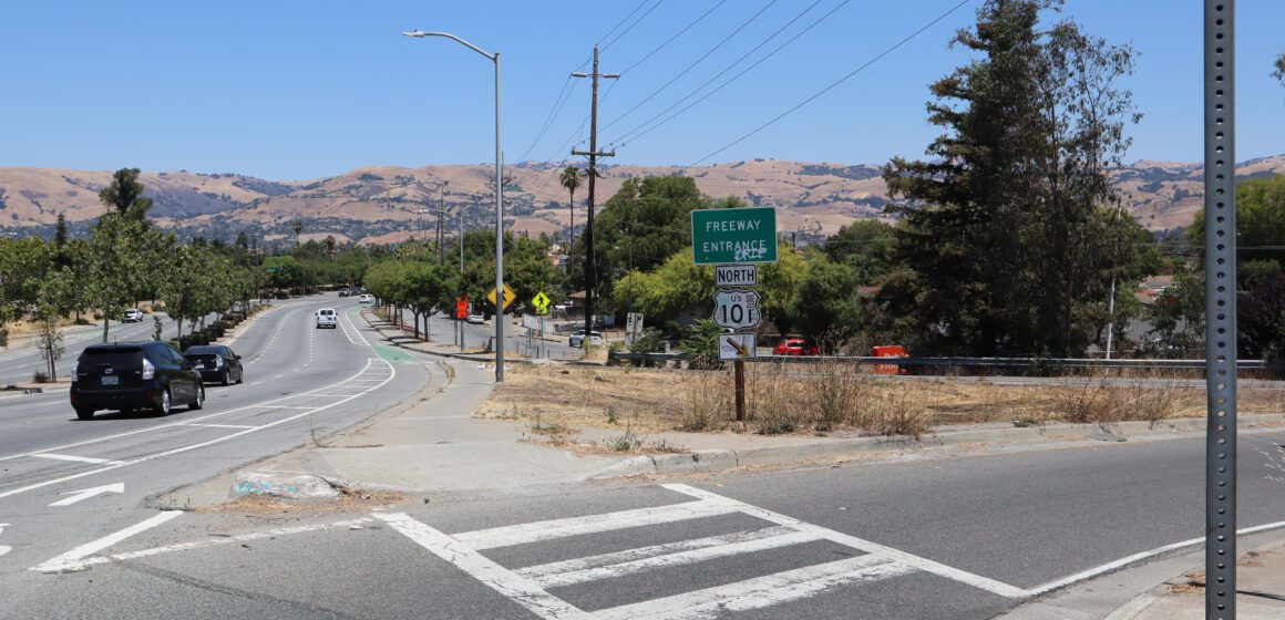 Photo of the highway 101 north entrance on Story road, with the highway and "Freeway entrance" signs visible and cars driving along Story Road in the background