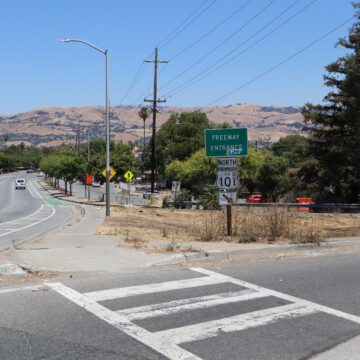 Photo of the highway 101 north entrance on Story road, with the highway and "Freeway entrance" signs visible and cars driving along Story Road in the background