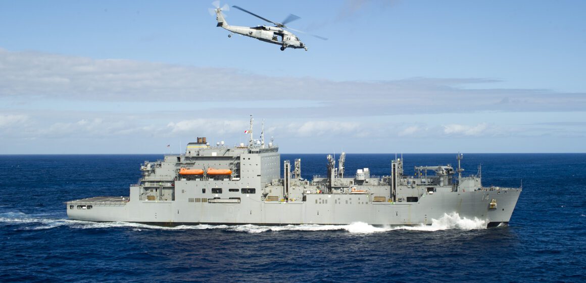 Navy ship with helicopter above