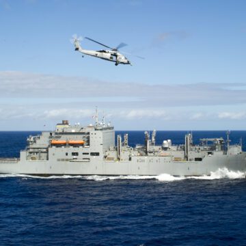 Navy ship with helicopter above