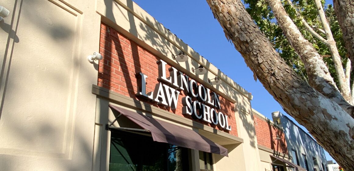 Photo of the exterior facade of Lincoln Law School, a beige and brick single-floor building with dark awnings over the window
