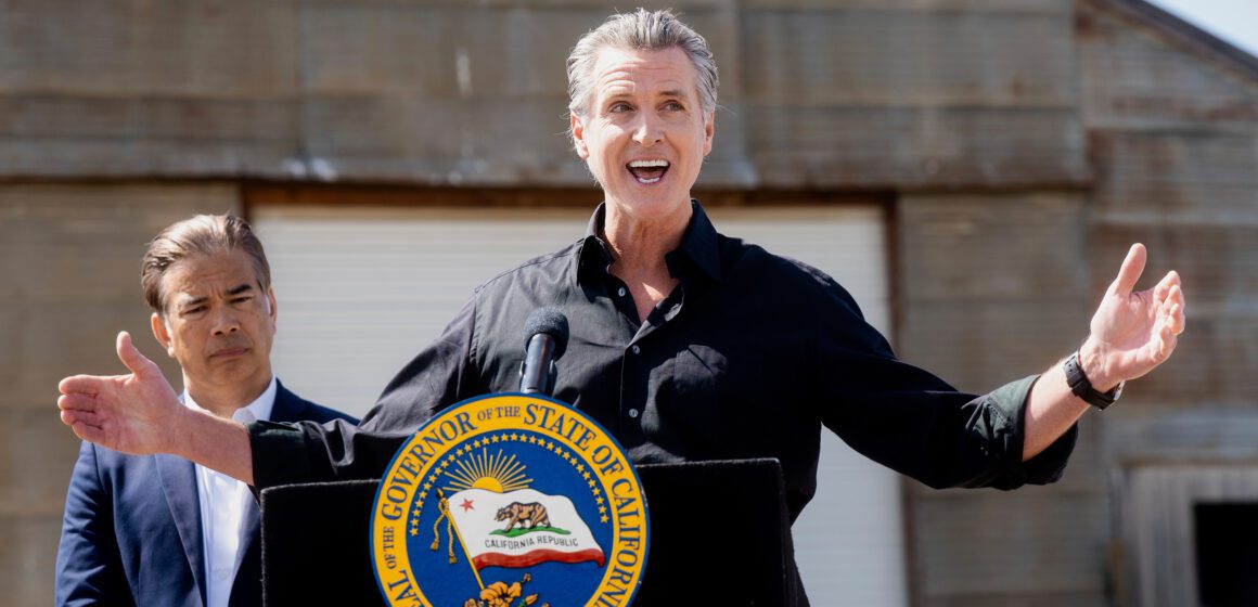 California Tariffs Lawsuit California Governor Gavin Newsom speaking outside behind a podium