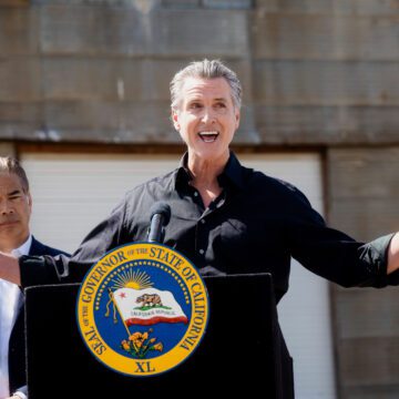 California Tariffs Lawsuit California Governor Gavin Newsom speaking outside behind a podium