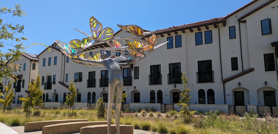 An artistic statue in front of a building in Cupertino
