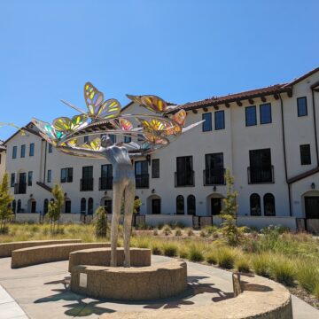 An artistic statue in front of a building in Cupertino