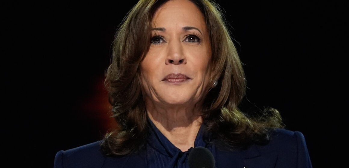 Former U.S. Vice President Kamala Harris stands in front of a microphone