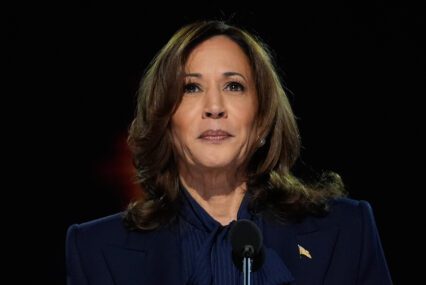 Former U.S. Vice President Kamala Harris stands in front of a microphone