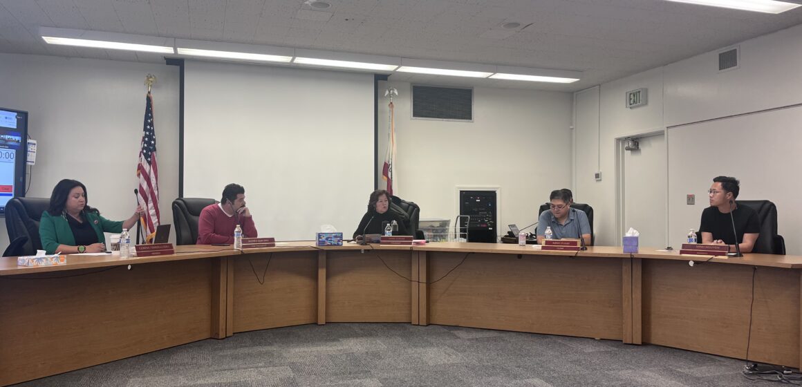 Men and women sitting behind a dais at a school board meeting in San Jose, California