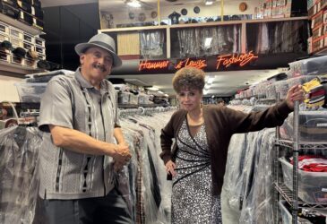 A man and woman standing in a clothing store