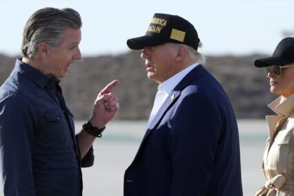 California Governor Gavin Newsom speaks with President Donald Trump and First Lady Melania Trump at Los Angeles International Airport
