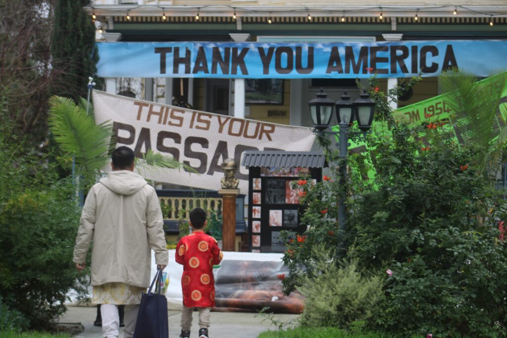 A man and child stand in front of the Viet Museum in San Jose, California